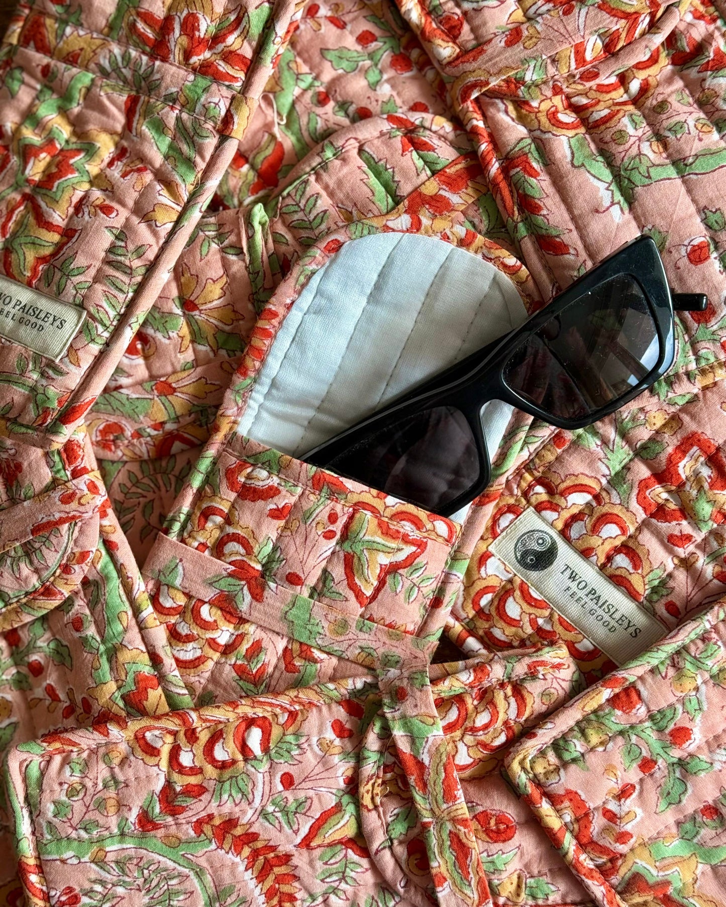 Pink and red floral quilted cotton glasses case with padded lining and sunglasses, part of a matching handmade accessories collection by Two Paisleys”