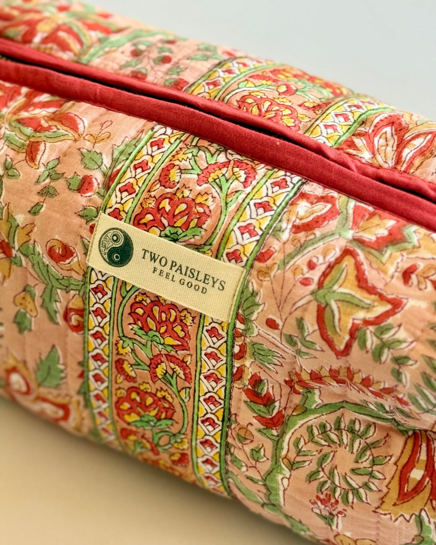 Floral Patterned quilted make up bag with a visible brand label on a neutral background