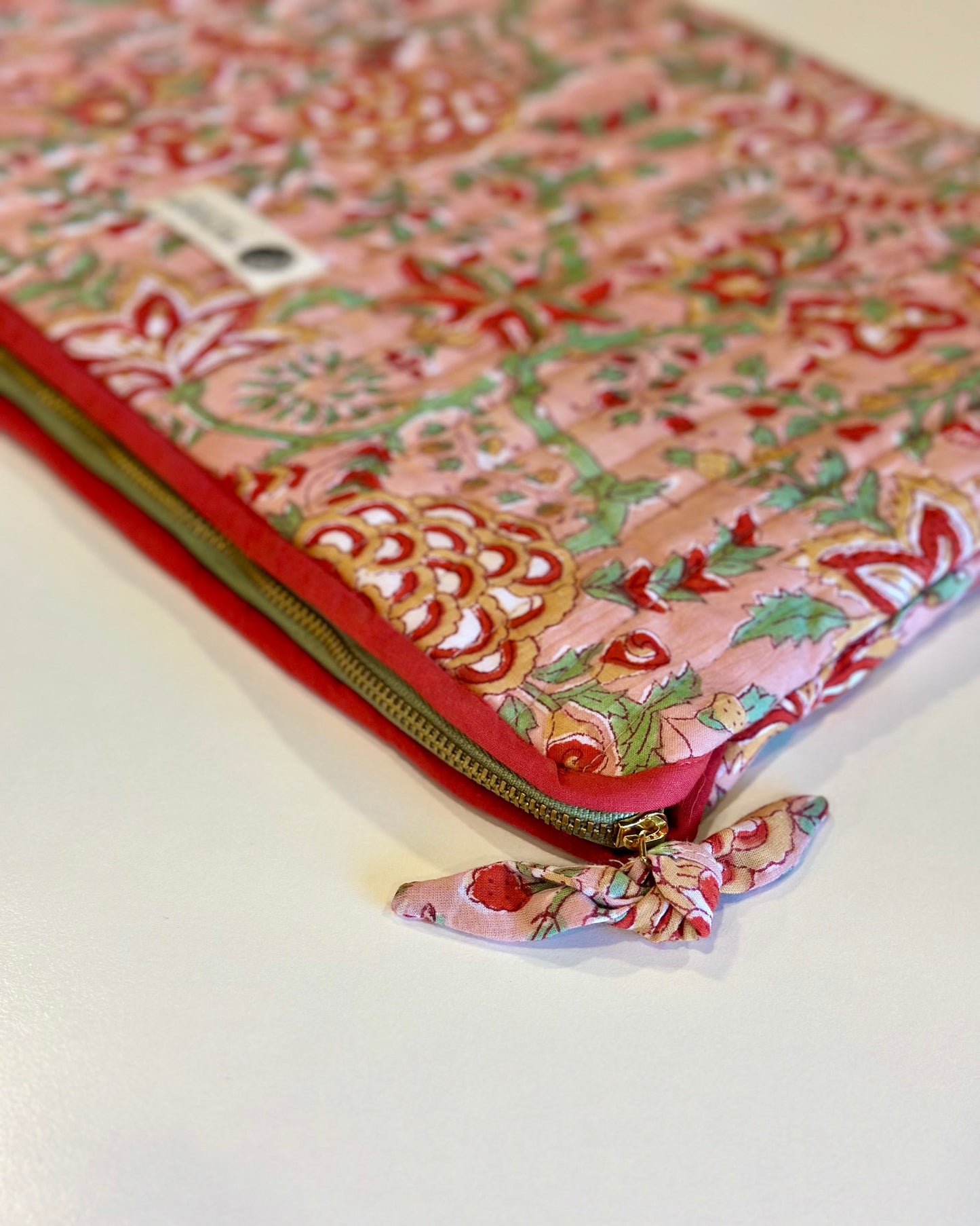 Floral patterned pouch with a zipper on a white background