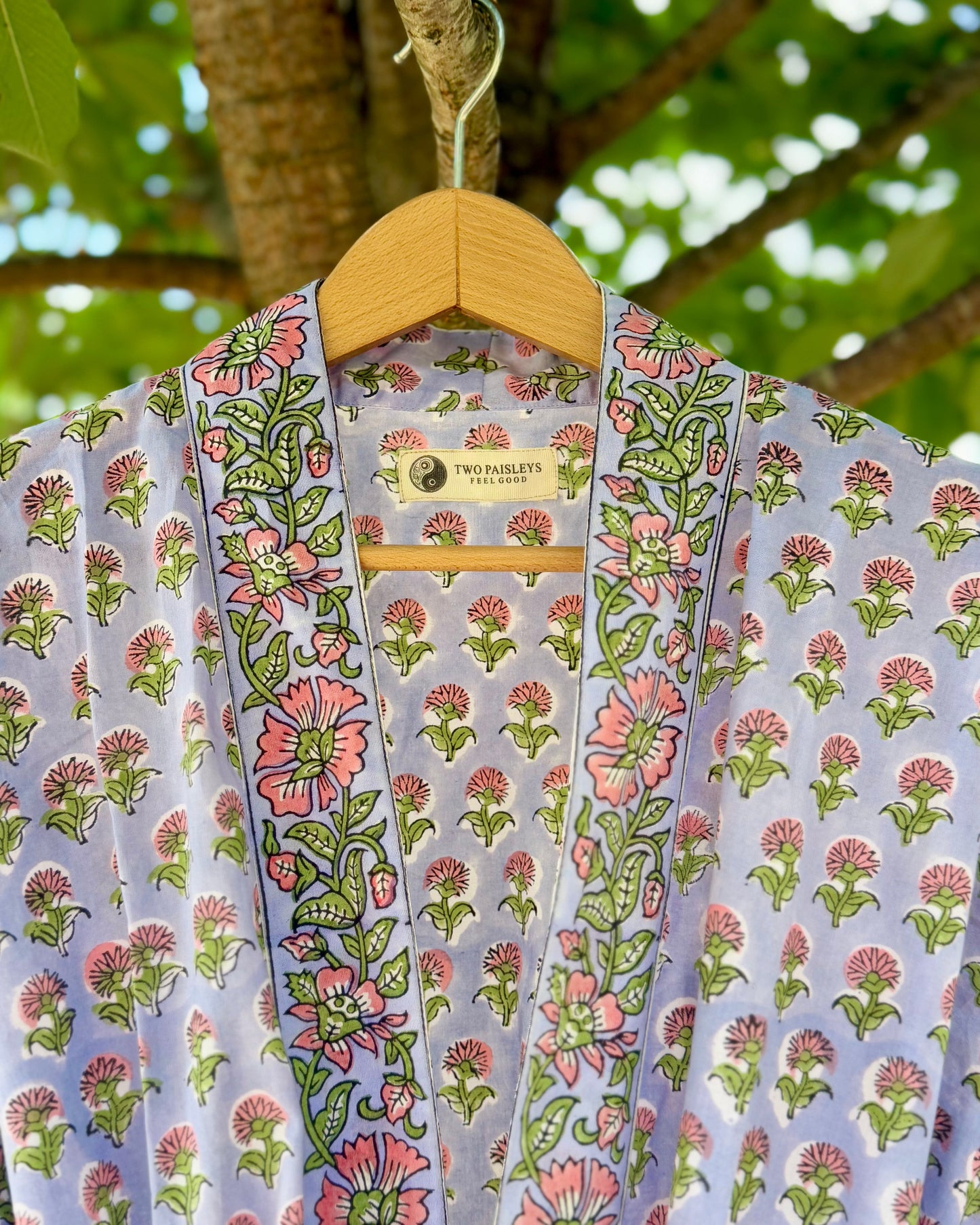 Close-up of collar and label on a lilac floral block printed cotton dressing gown, showing intricate hand block print detail and Two Paisleys branding.