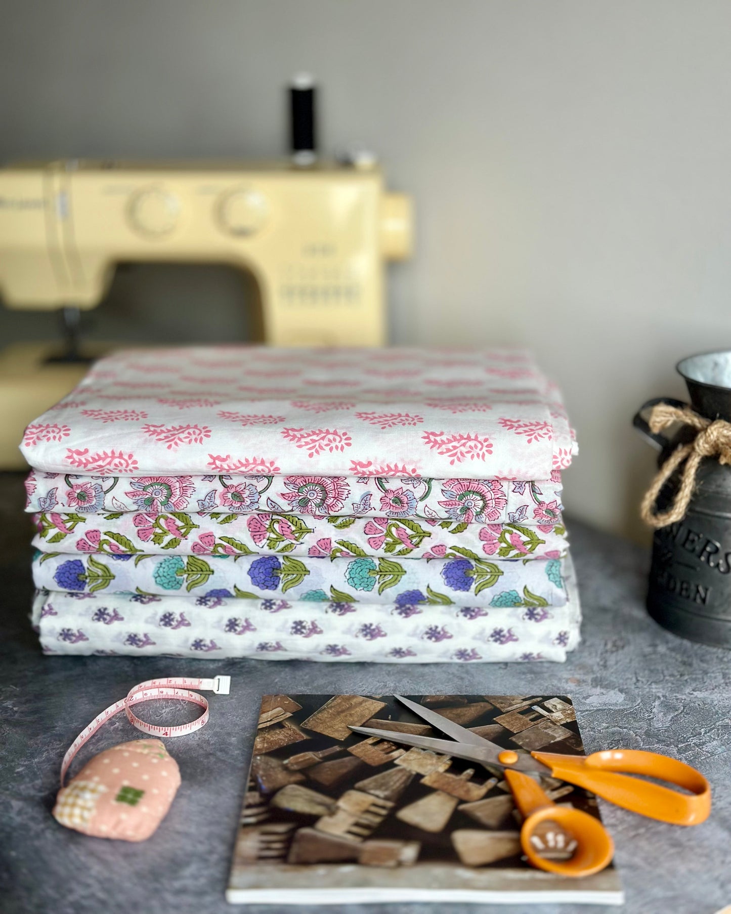 Stack of light hand block printed cotton fabrics.