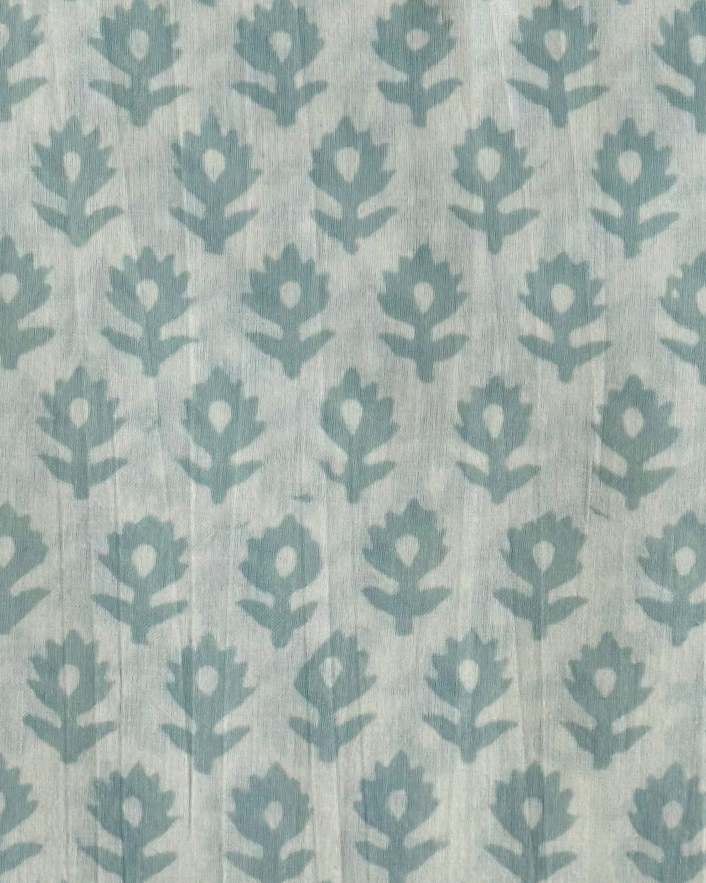 A close-up of our Heritage Buta block print fabric in a light mint on a natural cotton background.