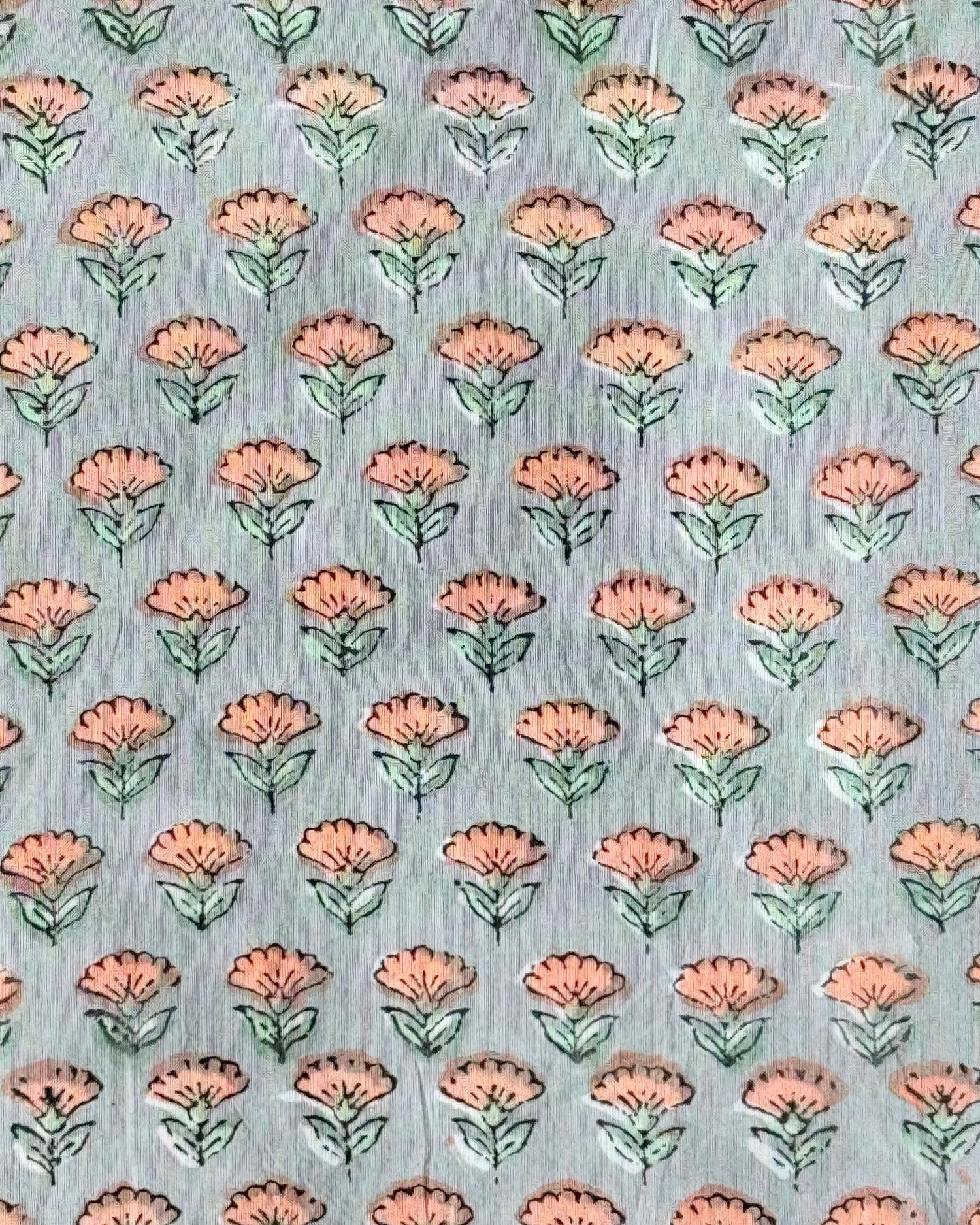 A close-up of the Apricot Grove Buti Hand Block Print Cotton Fabric, showcasing the delicate peach floral pattern on a sophisticated grey background.