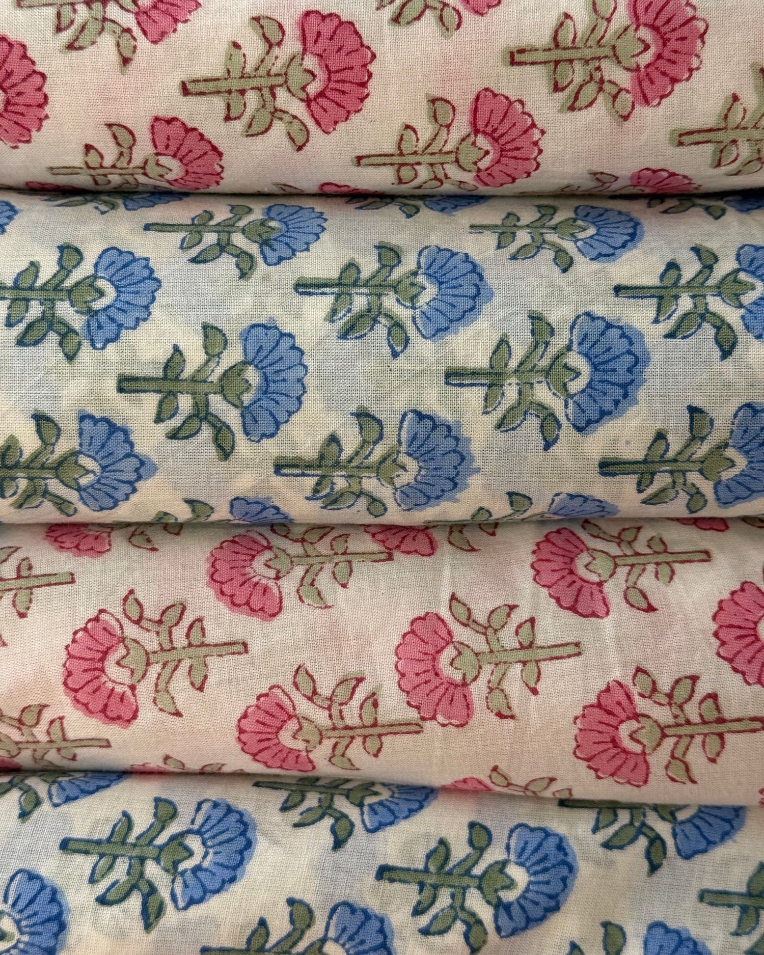 Floral fabric swatches with pink, blue, and green patterns.