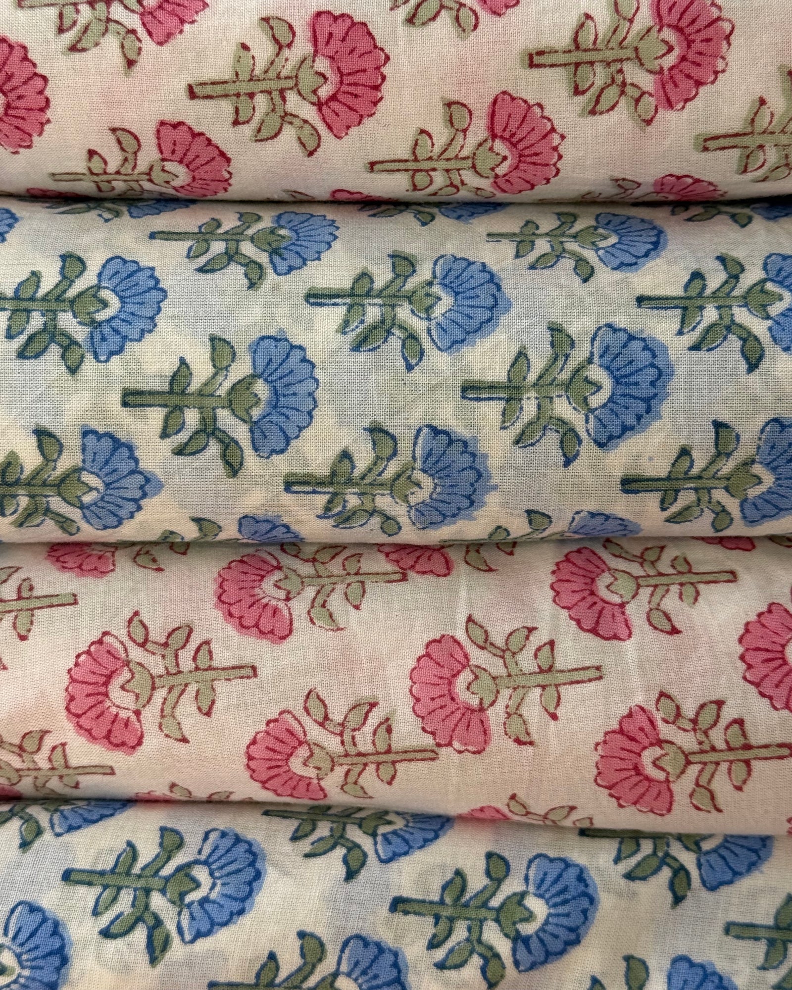 Floral fabric swatches with pink, blue, and green patterns.