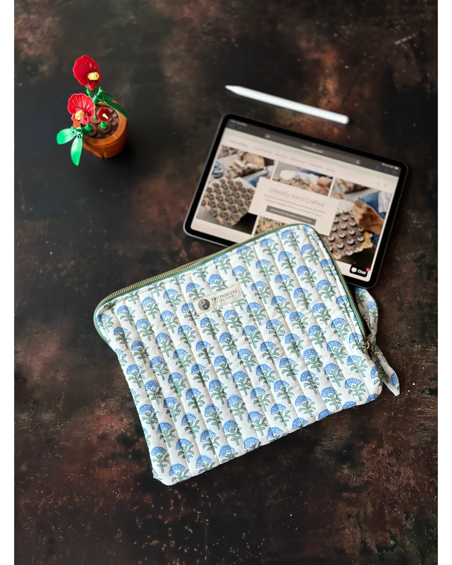 Slim padded iPad Sleeve & Organiser Lite for work and travel displayed on a table with an iPad Pro with Apple Magic Keyboard and an Apple Pen beside it.