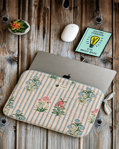 Hand Block Printed Blue Striped Floral Quilted Laptop Sleeve on a wooden desk with a notebook and wireless mouse.