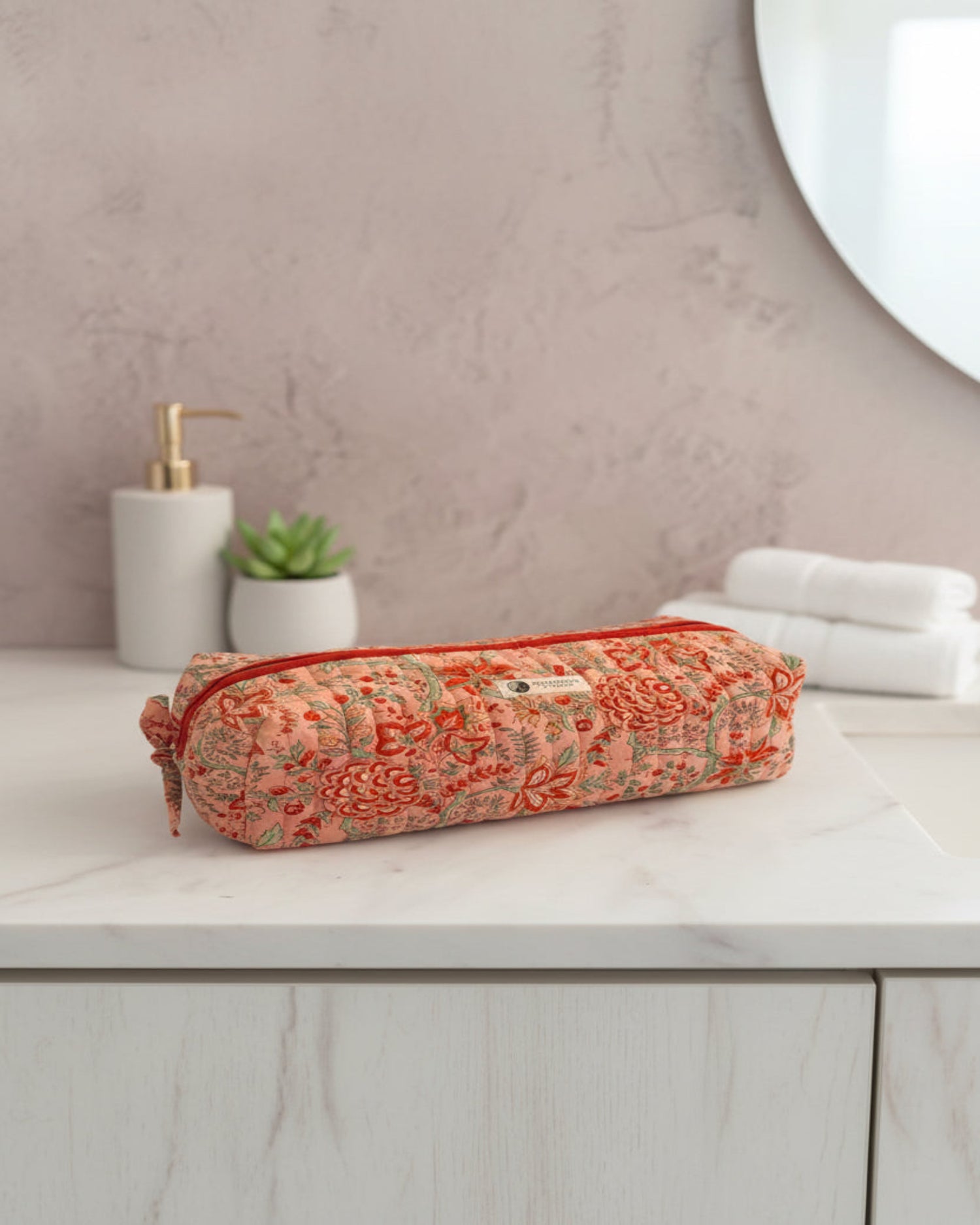 Coral Floral quilted hair tools bag by Two Paisleys, long cotton travel case with red zip and handle, front view.