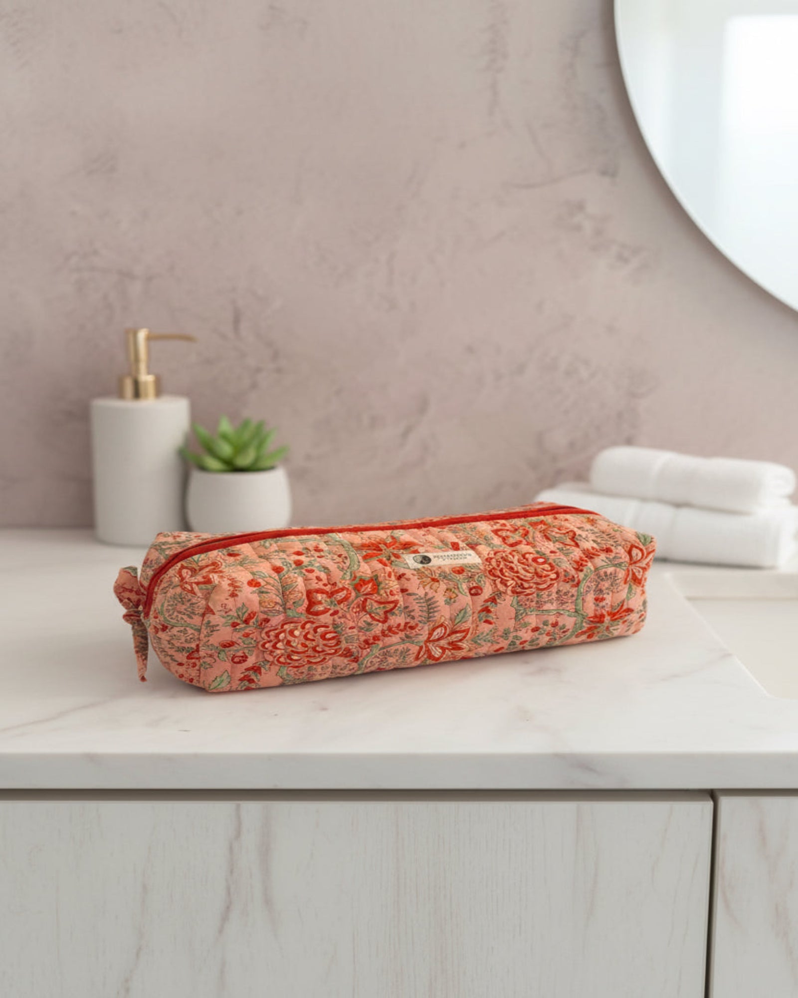 Coral Floral quilted hair tools bag by Two Paisleys, long cotton travel case with red zip and handle, front view.