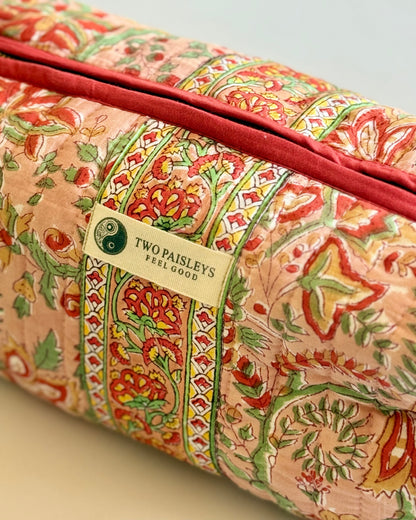 Floral Patterned quilted make up bag with a visible brand label on a neutral background
