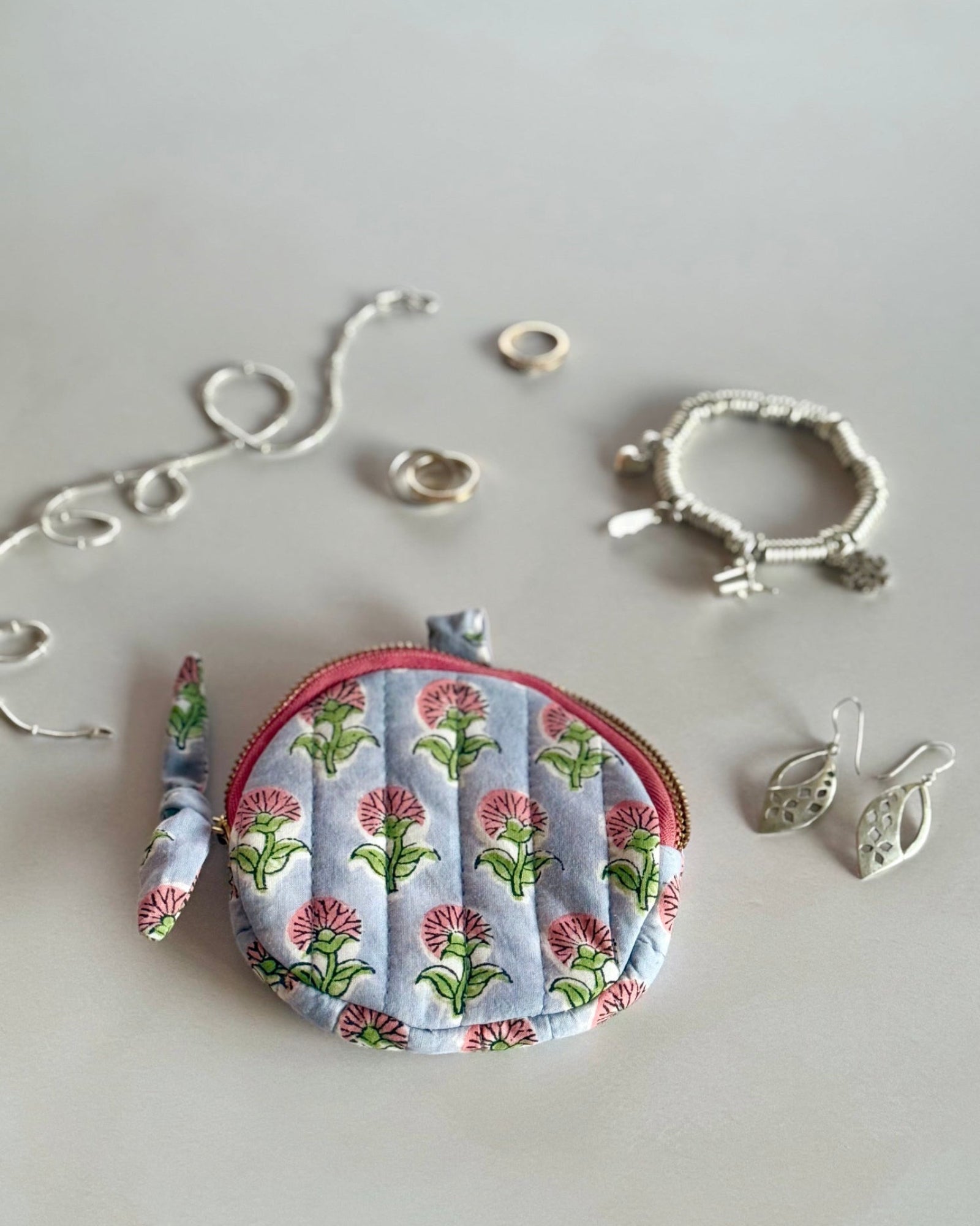 Ditsy  Daisy round cotton pouch styled with silver jewellery and cosmetics