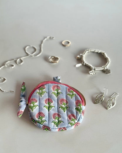 Ditsy  Daisy round cotton pouch styled with silver jewellery and cosmetics