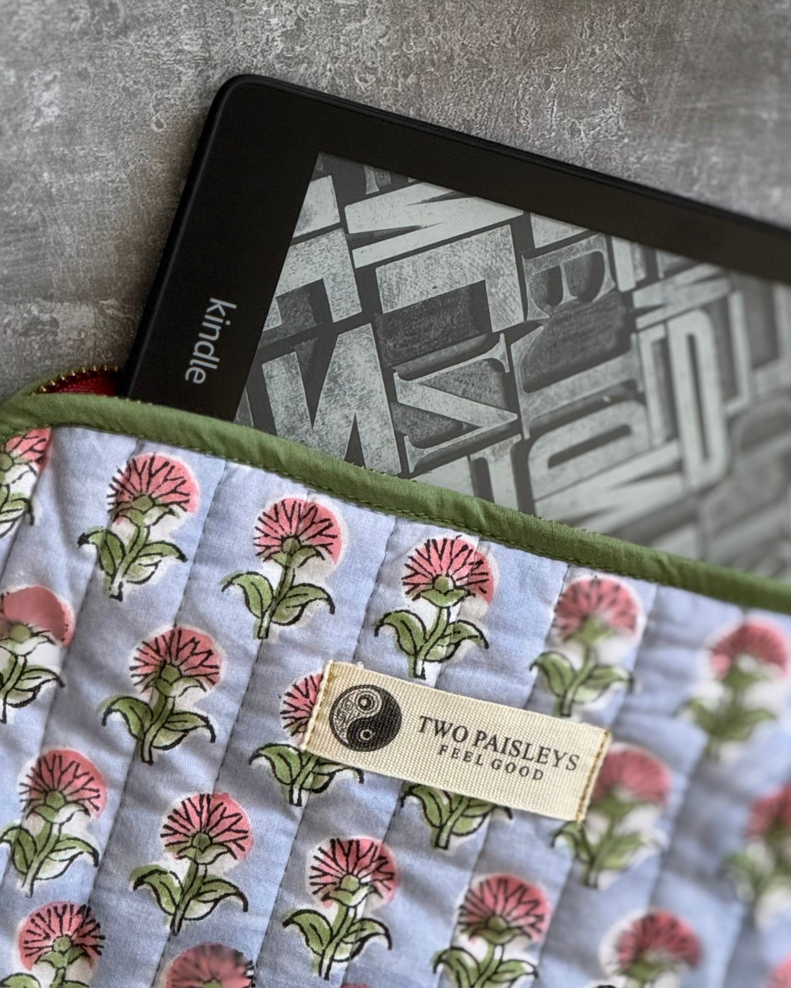 Floral-patterned fabric with a Kindle device on a textured surface
