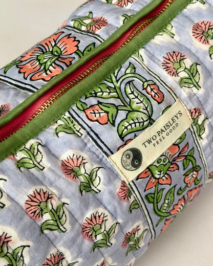 Side profile of the structured cotton wash bag showing floral pattern.