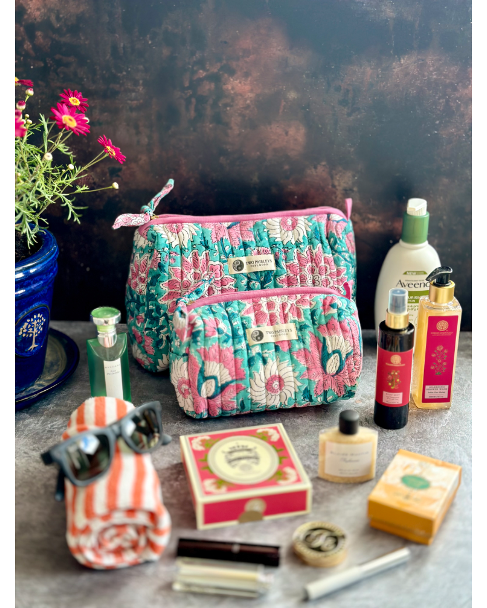 Garden of Eden Toiletry Bag styled with cosmetics and toiletries.

