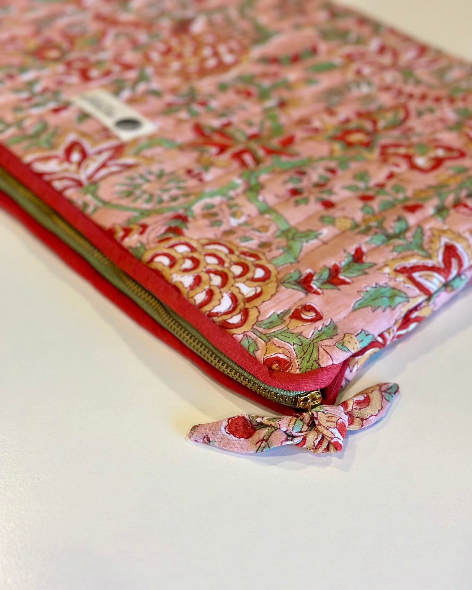 Floral patterned pouch with a zipper on a white background