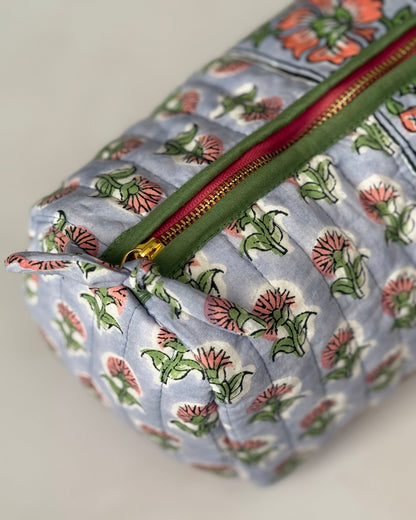 Detail view of gold zip with green piping a