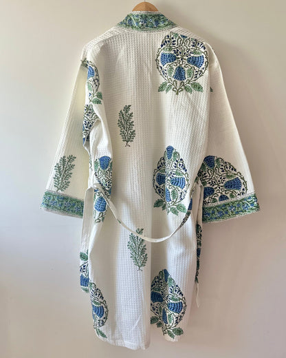 White waffle dressing gown with blue and green floral patterns on a plain background