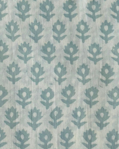  A close-up of our Heritage Buta block print fabric in a light mint  on a natural cotton background.