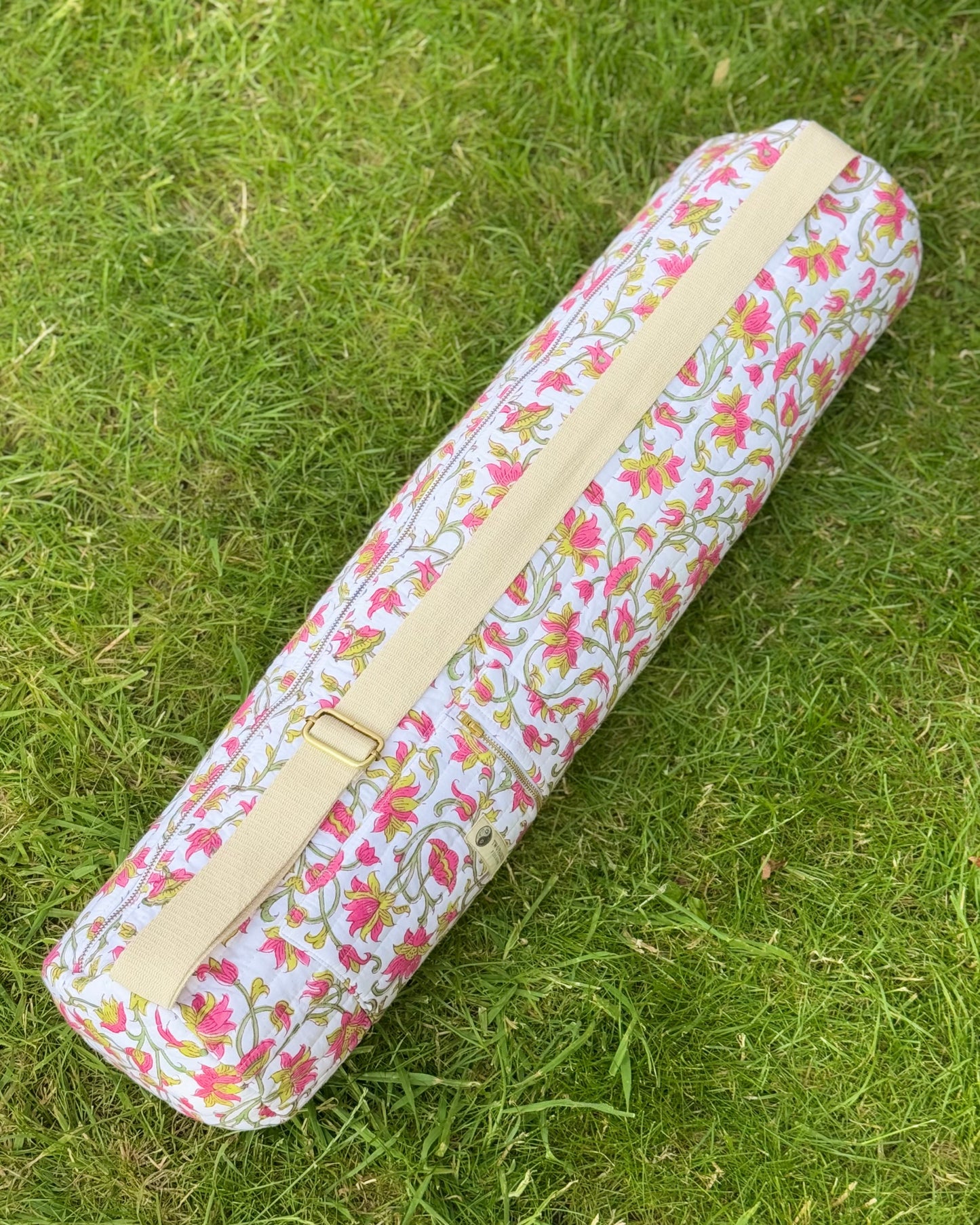 Floral-patterned yoga mat bag on grass