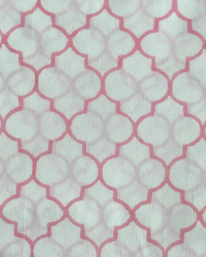 A close-up of the Rose Trellis Hand Block Print Cotton Fabric, showcasing the classic geometric quatrefoil pattern in a fresh rose pink
