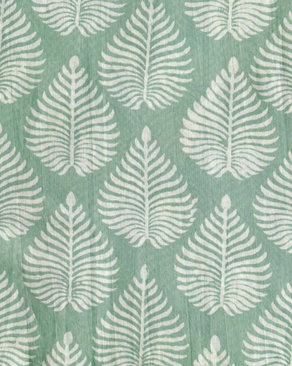 A swatch of the Fern Garden cotton fabric in sage green, showing the detailed white fern pattern