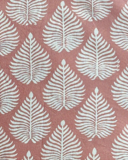 A close-up of our Fern Garden discharge block print fabric in a soft terracotta  colour
