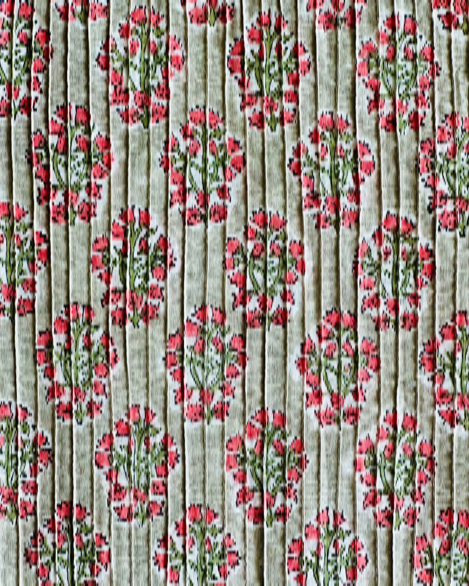 A detailed close-up of the Verdant Rose Hand Block Print Pintuck Fabric, showing the fine vertical pintucks and the coral floral pattern on a sage green background.