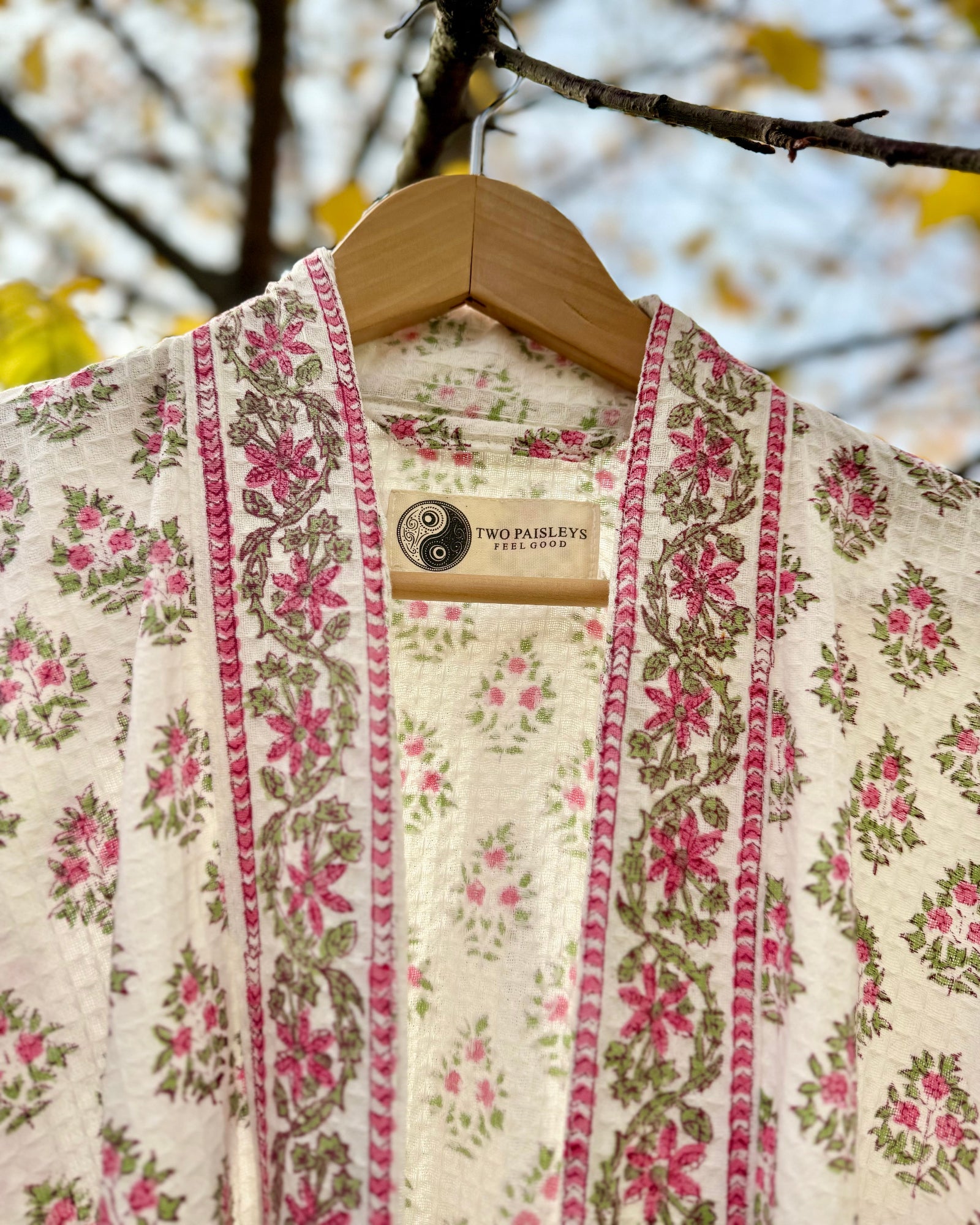 Close-up detail of the Vintage Floral waffle robe collar and the Two Paisleys label.