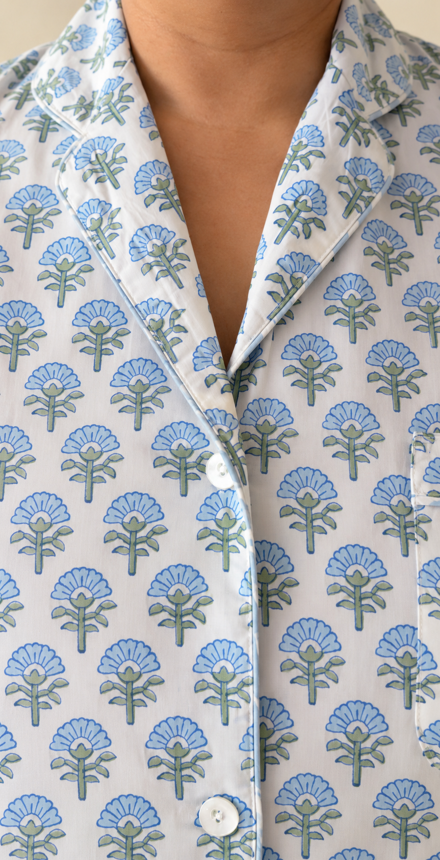 Close-up of notch collar and buttons on Two Paisleys hand block printed cotton pyjama shirt in blue floral pattern