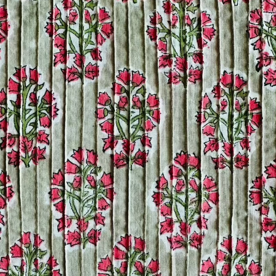 Detailed view of the Two Paisleys Verdant Rose fabric, showcasing the beautiful combination of pintucking and a vibrant floral buta print