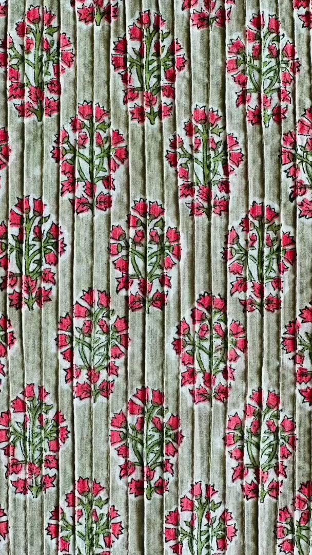 Detailed view of the Two Paisleys Verdant Rose fabric, showcasing the beautiful combination of pintucking and a vibrant floral buta print