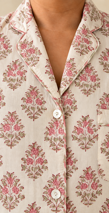 Close-up of notch collar and buttons on Two Paisleys hand block printed cotton pyjama shirt in vintage pink floral pattern